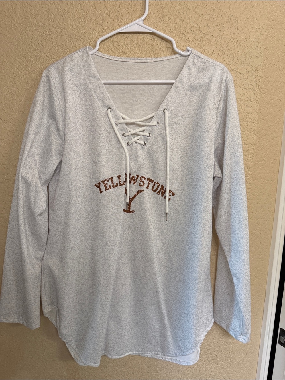 Lace-Up Pullover in Light Gray with Brown Yellowstone logo .